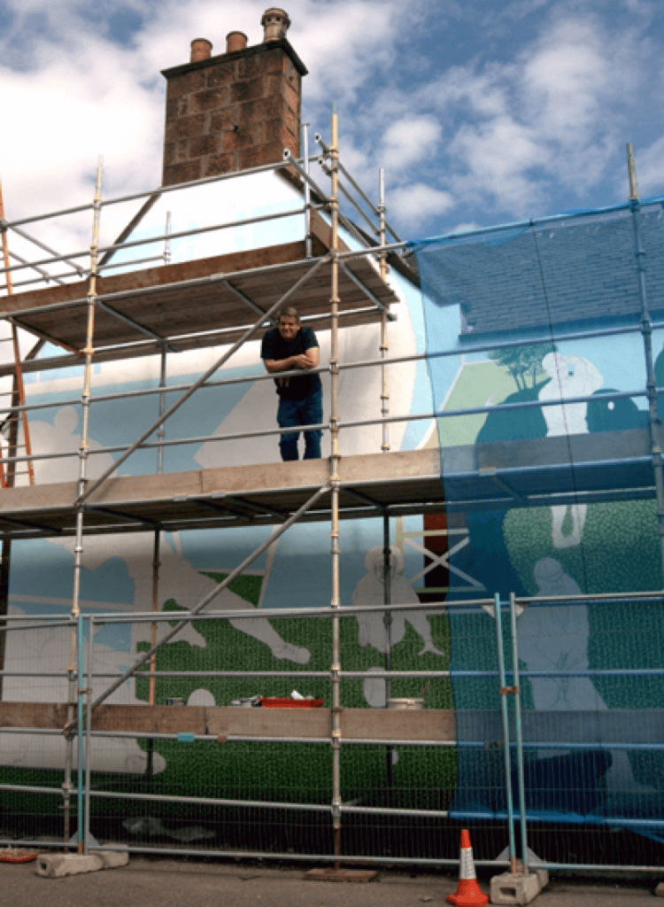 image of Alan Potter the artist on the scaffolding during painting